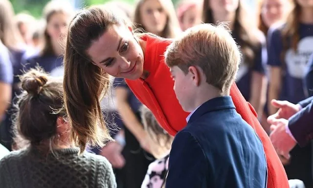 Kate Middleton wore a long red coat. Princess Charlotte wore a navy frock coat by AmaiaKids Razorbil and blue Mary Jane shoes