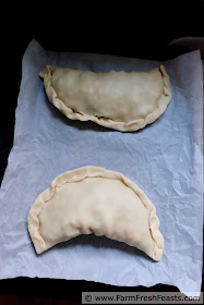 pie crust crimped around sausage and vegetable filling