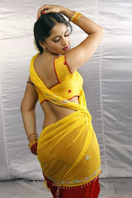 Anuskha Shetty giving a strong appeal to her audiences by wearing a yellow, backess blouse & saree.