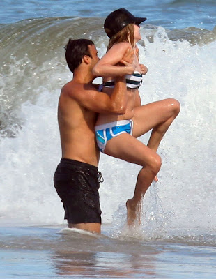 Avril Lavigne in wet bikini top and blue shorts having fun in Malibu Beach 