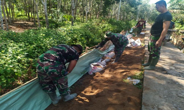 Pemasangan Plastik Cor oleh Anggota Satgas Perkuat Betonisasi Jalan TMMD