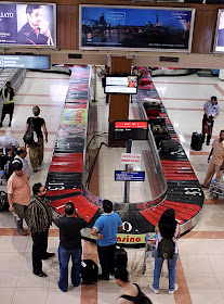 suitcases on luggage belt at airport