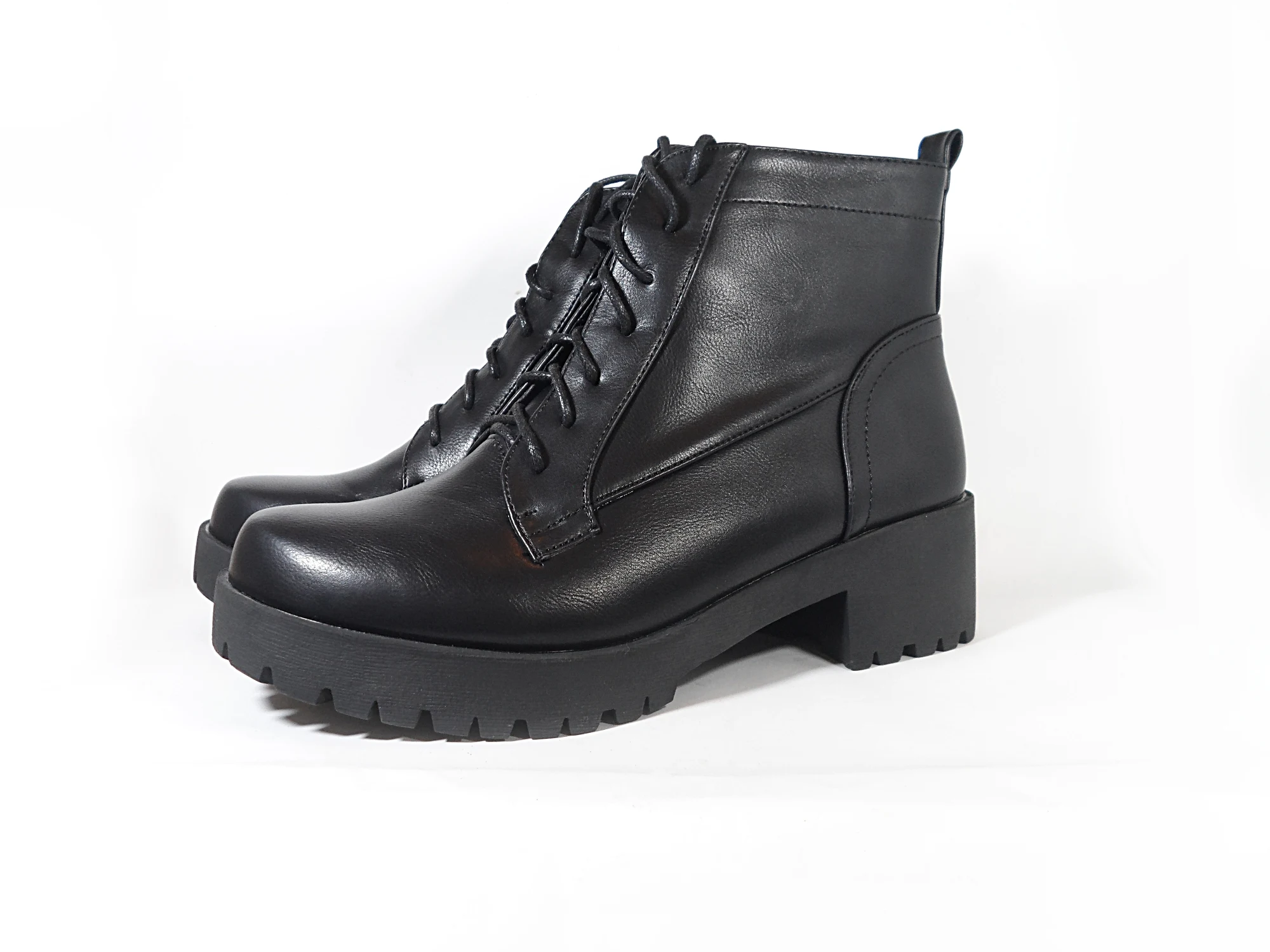 close-up of a black combat boots on a white background in the studio