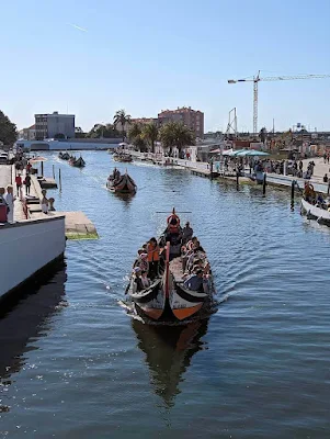 Moliceiros in the canal in Aveiro Portugal