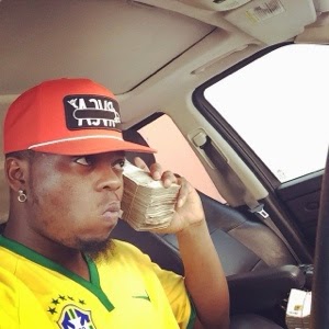 PHOTOS: Olamide Shows Off Stacks Of Naira And Sends Out Warning To Haters