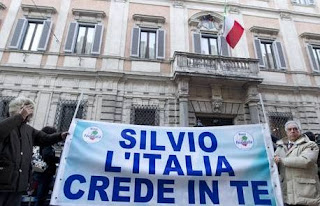 Silvio Berlusconi's fans showing a banner that reads "Silvio Italy trusts in you"