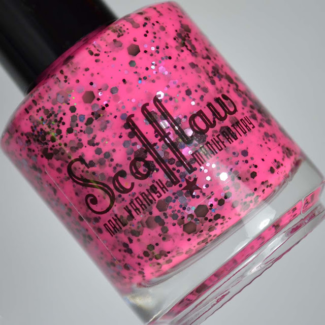 neon pink nail polish with glitter in a bottle