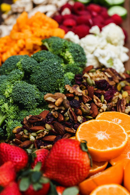 A vibrant assortment of antioxidant-rich fruits, including juicy oranges, ripe strawberries, and a variety of nuts.