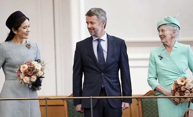 Crown Princess Mary wore a pale blue coat by Claes Iversen. Gianvito Rossi pumps. Jane Taylor purple hat