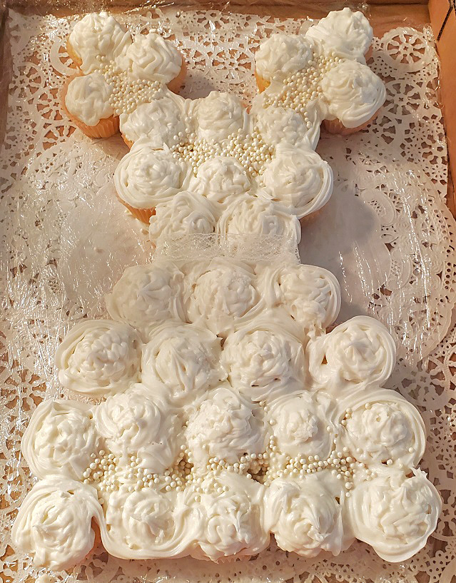 cupcakes shaped into a bridal dress decorated