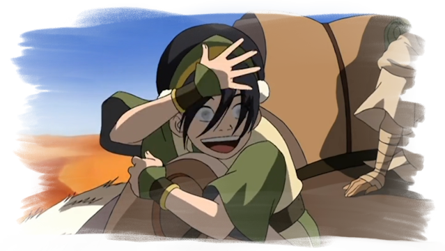A picture of Toph waving her hand in front of her face with an exaggerated smile to remind the others she's blind.