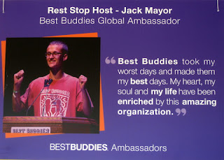 Sign featuring Rest Stop Host - Jack Mayor, Best Buddies Global Ambassador. Quote: Best Buddies took my worst days and made them my best days. My heart, my soul and my life have been enriched by this amazing organization.