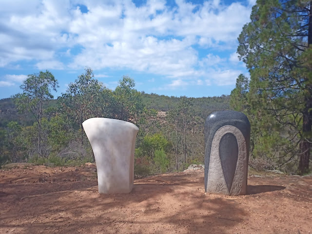 European and Aboriginal axehead sculptures in the bush