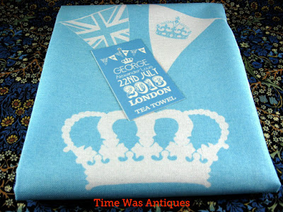 https://timewasantiques.net/products/tea-towel-prince-george-birth-william-kate-blue-and-white-2013-royal-birth