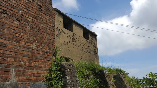 Building with bullet holes damages at the top of the Hai Van Pass.