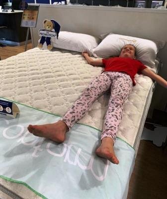 Bed King Comfort Solutions - girl testing bed