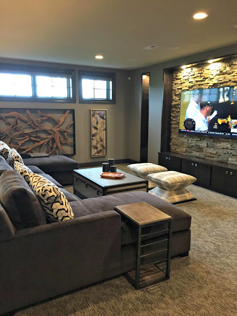 stone wall behind TV in basement