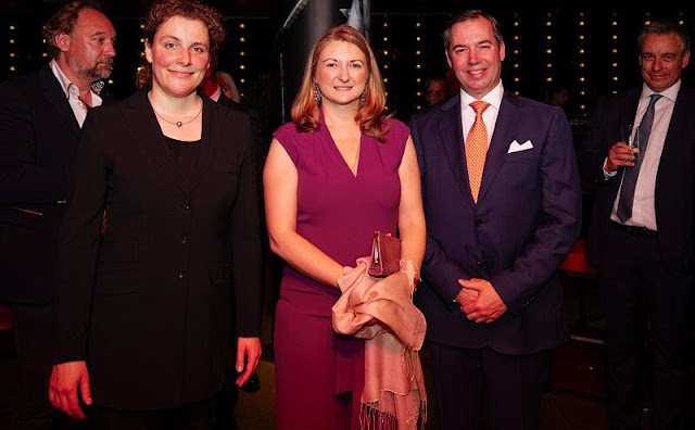 Princess Stephanie wore a purple sleeveless jumpsuit with nude pumps. Sophie Habsburg clutch