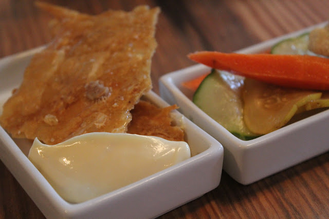 Fried chicken skin and pickled vegetables at West Bridge, Cambridge, Mass.