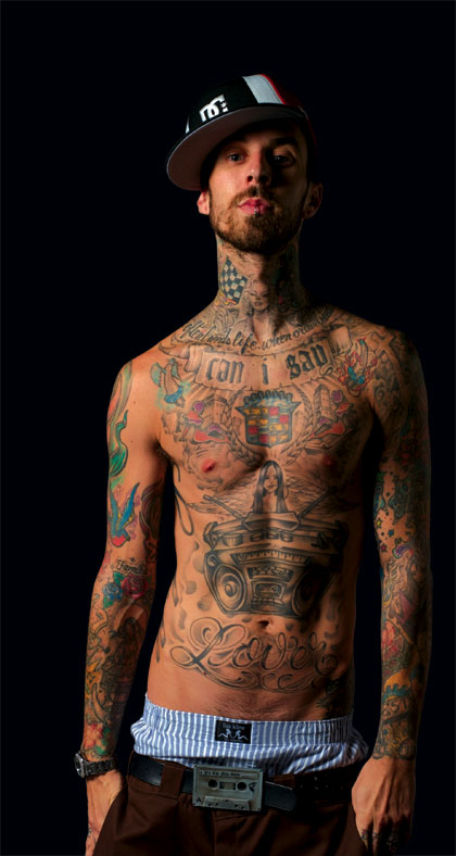 Travis Barker tattoos combination of old school and new school tattoos.