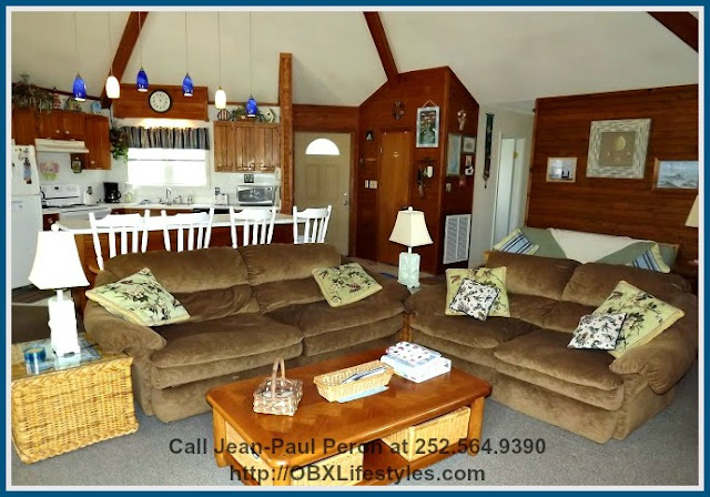 Sit back, relax, and put your feet up as you marathon your favorites movies or enjoy the view of the blue skies from the living room of this canal front Corolla NC home for sale.