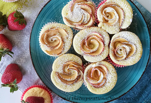 apple roses baked into cupcakes on a blue plate with fresh strawberries, apple rose cupcakes, apple cupcakes, box cupcake hack, fluffy, moist, light, fruit, apple, no icing, no frosting, without frosting, Mother's Day