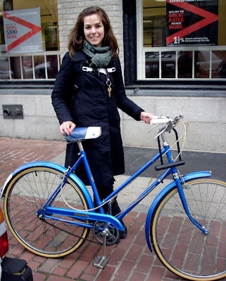 Blue Triumph bicycle with pretty girl