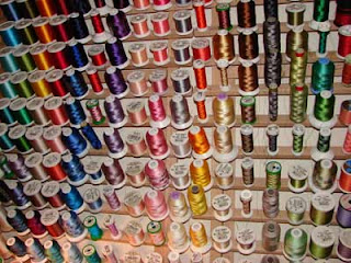 Colorful embroidery threads hanging on a wallmounted thread rack