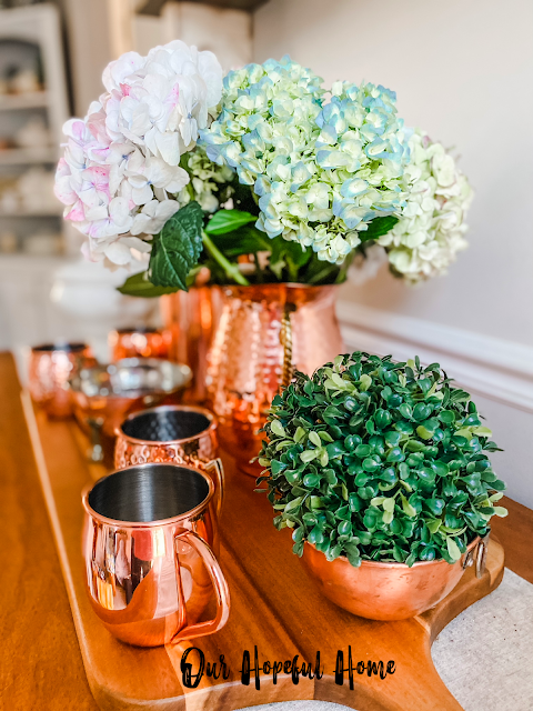 romantic fresh hydrangeas hammered copper pitcher copper mugs