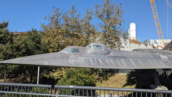 With a retired A-12 Blackbird in the foreground, space shuttle Endeavour's twin solid rocket motors stand tall at the construction site for the California Science Center's Samuel Oschin Air and Space Center in Los Angeles...on November 8, 2023.