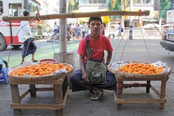 Boy Selling Fruit on Rangoon Sidewalk 480