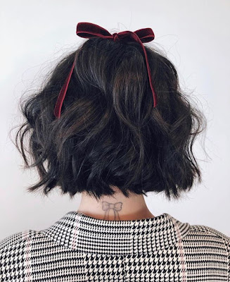 Lucy Hale tattoo bow back of neck. Matching bow in hair hairstyle