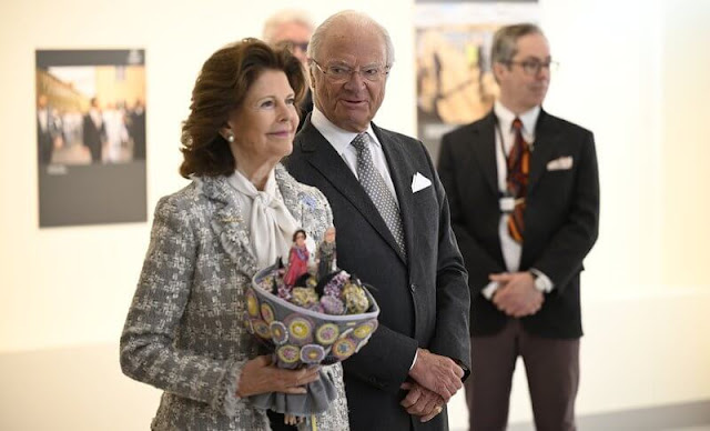 Queen Silvia wore a tweed jacket by Chanel, and she wore a white wool and cashmere cape, and a silk blouse