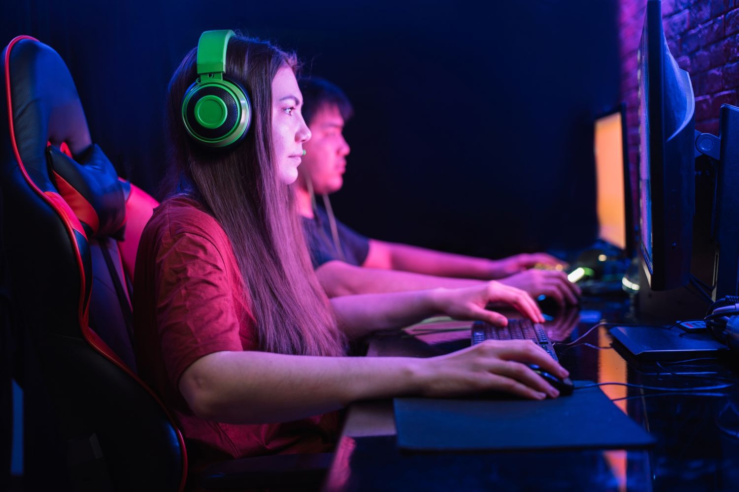 A female gamer, shown gaming.