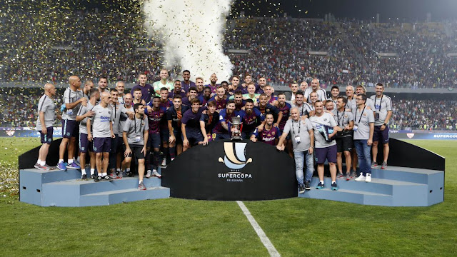 Barcelona players lifting the Spanish super cup after their 2-1 win against Sevilla