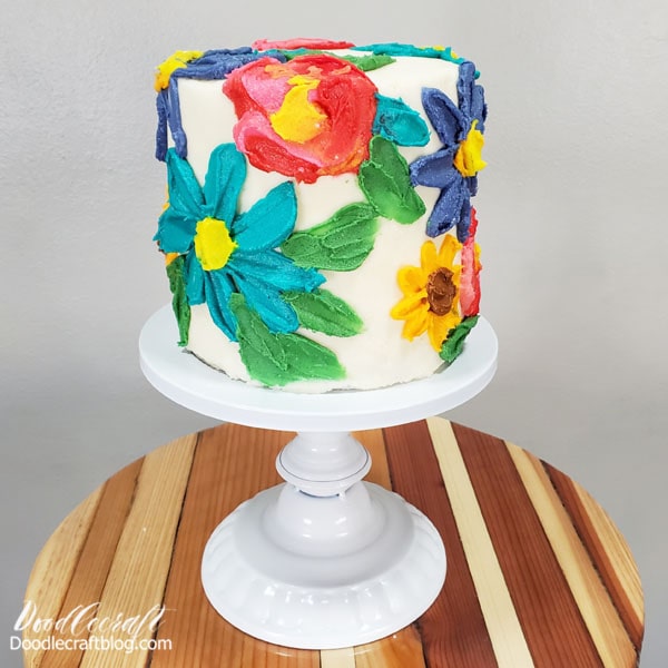 How to Make a Palette Knife Floral Cake!  Learn how beautiful and simple it is to make a palette knife floral cake. This technique is something you can do with thick acrylic paint on canvas too.   This art project is fun because the canvas is a beautiful and edible cake and the paint is creamy delicious buttercream frosting!