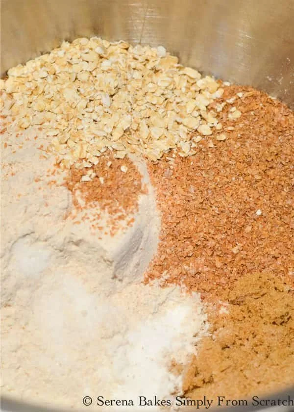 Mixing bowl with whole wheat flour, all-purpose flour, wheat bran, wheat germ, brown sugar, quick oats, baking soda, and salt to make Irish Brown Bread recipe.