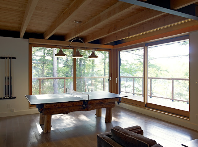 Photo of wooden table tennis table in the gaming room of the forest house