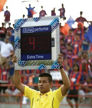 Fourth official holds up a massive electronic condom aloft