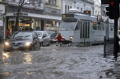 Tram ahoy ... flooding yesterday on the corner of Chapel Street and Commercial Road in Prahran, Melbourne. Photo: Sebastian Costanzo