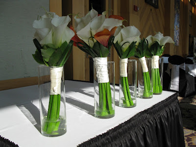 This elegant centerpiece has white calla lilies paired with white veronica