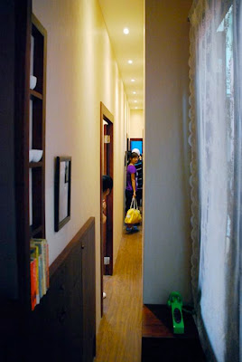 Narrow House is one of the many ways that Austrian artist Erwin Wurm looks at the world differently and challenges his viewers to do the same. Wurm created this installation based off of his childhood home. Visitors were invited into the living quarters to explore the narrow spaces and slender furniture that filled the house. Everything including the hallways, the bedroom, the living areas, even the toilet, were unusually compressed. Through the installation, Wurm raises questions about space, posing "some deep and disturbing questions about the terror that comes from having our personal space constricted, restricted, or invaded."