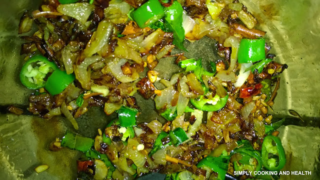 Onion,chili,garlic,and spices frying in awok