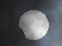 Hazy phot of a barely crescent sun seen during the April 8, 2024 eclipse.