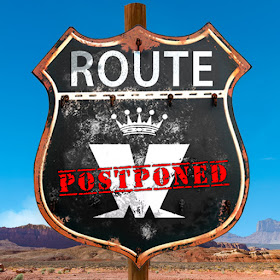 A highway route sign in the desert displays the 'M" Madness logo and has the word 'postponed' stamped over it.