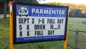 Parmenter School sign with opening schedule for 2014-2015 school year