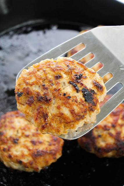 cooked patty on a metal spatula.