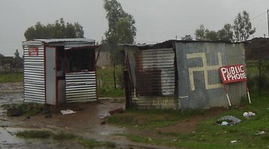 Swastika painted on the side of a phone booth shed in Lesotho.