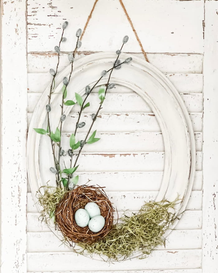 spring wreath on oval picture frame, birds nest, pussy willow