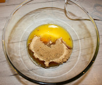 Glass bowl containing egg, melted butter and sugar
